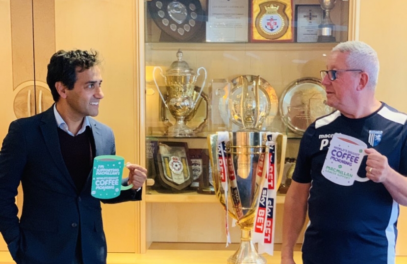Rehman with Gills Chairman holding Macmillan cut-out mugs
