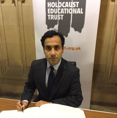 Rehman signing the Holocaust Memorial Book