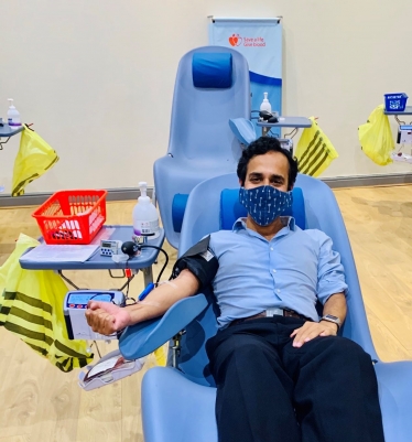 Picture of Rehman donating blood
