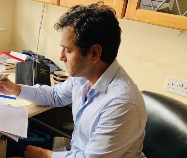 Rehman at his desk